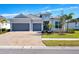 Beautiful two-car garage home featuring an inviting entrance and manicured landscaping at 25186 Keygrass Ct, Punta Gorda, FL 33955