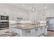 Modern kitchen featuring stainless steel appliances, ample cabinet space, and island seating at 25186 Keygrass Ct, Punta Gorda, FL 33955