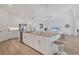 Bright kitchen features a granite island with seating and stainless steel appliances at 25186 Keygrass Ct, Punta Gorda, FL 33955