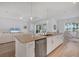 Kitchen island with sink and bar seating, open to the living and dining area at 25186 Keygrass Ct, Punta Gorda, FL 33955