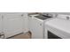 Well-equipped laundry room with a washer, dryer, utility sink, and cabinet at 25186 Keygrass Ct, Punta Gorda, FL 33955