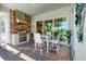 Screened patio with outdoor kitchen and dining set overlooking the lush landscaping at 25186 Keygrass Ct, Punta Gorda, FL 33955