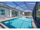 Sparkling screened-in pool and spa with outdoor seating area, perfect for relaxing and entertaining in style at 25186 Keygrass Ct, Punta Gorda, FL 33955