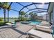 Enjoy the Florida sunshine in your private screened-in pool and spa, surrounded by lush landscaping and serene views at 25186 Keygrass Ct, Punta Gorda, FL 33955