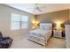 Comfortable bedroom features a ceiling fan, a window with blinds, and a queen size bed at 2555 Thyme Way, North Port, FL 34289