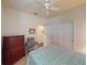 Comfortable bedroom with a ceiling fan, closet, and dresser, offering a relaxing retreat at 2555 Thyme Way, North Port, FL 34289