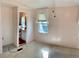 Bedroom showcasing an ensuite bathroom, neutral carpet and a window with lace curtains at 258 Palm Harbor Dr, North Port, FL 34287