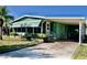 Charming home with a covered carport, awning, and mature landscaping at 258 Palm Harbor Dr, North Port, FL 34287