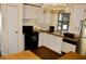 Bright kitchen with stainless steel refrigerator, white cabinets, and laminate wood floor at 258 Palm Harbor Dr, North Port, FL 34287