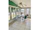 Enclosed porch features tiled floors, ceiling fan and an abundance of windows at 258 Palm Harbor Dr, North Port, FL 34287