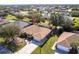 Expansive aerial view of the tan single-story home with an attached garage and screened-in patio at 27199 Punta Cabello Ct, Punta Gorda, FL 33983