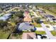 Aerial view of the home in a quiet neighborhood with well-maintained lawns and mature trees at 27199 Punta Cabello Ct, Punta Gorda, FL 33983