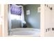 Bathroom with a large soaking tub under a window with a privacy blind at 27199 Punta Cabello Ct, Punta Gorda, FL 33983