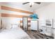 Comfortable bedroom with white furniture, tv, and natural light streaming from the window at 27199 Punta Cabello Ct, Punta Gorda, FL 33983