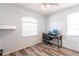 Bright bedroom featuring wood look floors, a desk, a ceiling fan and natural light at 27199 Punta Cabello Ct, Punta Gorda, FL 33983