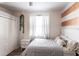 Bedroom featuring a closet, white bedding, a striped accent wall and new flooring at 27199 Punta Cabello Ct, Punta Gorda, FL 33983