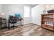 Bright bedroom featuring wood floors, a desk, and a closet for ample storage at 27199 Punta Cabello Ct, Punta Gorda, FL 33983