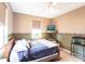 Cozy bedroom with a ceiling fan and natural light streaming through the windows at 27199 Punta Cabello Ct, Punta Gorda, FL 33983