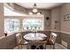 Bright breakfast nook boasts a round table with seating, set against a large window view of the outdoors at 27199 Punta Cabello Ct, Punta Gorda, FL 33983