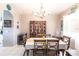 Elegant dining room featuring a vintage china cabinet and a chandelier over a large dining table at 27199 Punta Cabello Ct, Punta Gorda, FL 33983