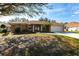 Charming single-story home featuring a well-manicured front lawn and an attached two-car garage at 27199 Punta Cabello Ct, Punta Gorda, FL 33983