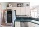 The kitchen has stainless steel appliances and white cabinets at 27199 Punta Cabello Ct, Punta Gorda, FL 33983