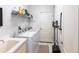 Laundry room with modern washer and dryer, ample shelving, and convenient sink at 27199 Punta Cabello Ct, Punta Gorda, FL 33983