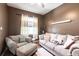 Comfortable living room features a plush sofa, chair, ottoman, neutral colors, and lots of natural light at 27199 Punta Cabello Ct, Punta Gorda, FL 33983