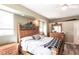 Comfortable main bedroom showcases wood-look floors, decorative headboard, and ample natural light at 27199 Punta Cabello Ct, Punta Gorda, FL 33983