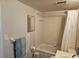 Bright bathroom with a shower-tub combination, neutral tiling, and a large vanity mirror at 3006 Caring Way # 409, Port Charlotte, FL 33952