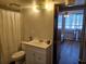 Bathroom with a shower-tub combination, neutral tiling, modern vanity, and access to the bedroom at 3006 Caring Way # 409, Port Charlotte, FL 33952