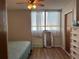 Bright bedroom with a ceiling fan, a window with natural light, and minimalist décor at 3006 Caring Way # 409, Port Charlotte, FL 33952