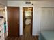 View from bedroom showcasing doorway to kitchen and hallway closet, complemented by neutral decor at 3006 Caring Way # 409, Port Charlotte, FL 33952