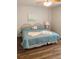 Cozy bedroom features calming colors, a ceiling fan, and beach themed wall art at 3006 Caring Way # 409, Port Charlotte, FL 33952