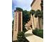 The Promenades building entrance and walkway is landscaped with beautiful greenery at 3006 Caring Way # 409, Port Charlotte, FL 33952
