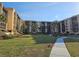 Exterior view showcasing the building and grounds with mature landscaping at 3006 Caring Way # 409, Port Charlotte, FL 33952