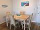 Bright dining room features a wooden table with seating for four, perfect for Gathering meals at 3006 Caring Way # 409, Port Charlotte, FL 33952