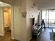 View of living room from entry, features a hallway bathroom and a screened lanai at 3006 Caring Way # 409, Port Charlotte, FL 33952