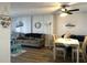 Open-concept living room featuring coastal decor and a dining area with ceiling fan at 3006 Caring Way # 409, Port Charlotte, FL 33952