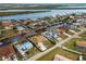 Aerial view showcasing a canal-side house and the surrounding neighborhood at 3370 Dover Dr, Punta Gorda, FL 33983