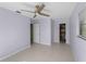 Light purple bedroom with tile floors, ceiling fan, and a closet at 3370 Dover Dr, Punta Gorda, FL 33983