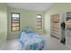 Simple bedroom with tiled floors and large bookcase at 3370 Dover Dr, Punta Gorda, FL 33983