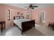 Bedroom with a wooden sleigh bed, tiled floors and a ceiling fan at 3370 Dover Dr, Punta Gorda, FL 33983