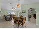 Open concept dining room with a view into the kitchen and living room at 3370 Dover Dr, Punta Gorda, FL 33983