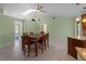 Dining room with a wooden table and chairs, light green walls, and skylights at 3370 Dover Dr, Punta Gorda, FL 33983