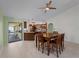 Kitchen and dining area with light green walls and wood cabinets at 3370 Dover Dr, Punta Gorda, FL 33983