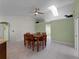 Dining room with a wooden table and chairs, light green walls, and skylights at 3370 Dover Dr, Punta Gorda, FL 33983