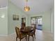 Bright dining room with a wood table and four chairs, leading to a view of the water at 3370 Dover Dr, Punta Gorda, FL 33983