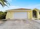Front view of the house with a white garage door at 3370 Dover Dr, Punta Gorda, FL 33983