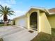 House exterior with attached garage and a palm tree at 3370 Dover Dr, Punta Gorda, FL 33983